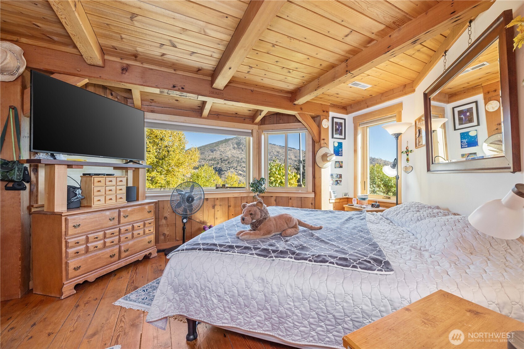 16495 South Lakeshore Road Chelan, WA 98816 - Photo 14 of 40 a living room with furniture a flat screen tv and a floor to ceiling window