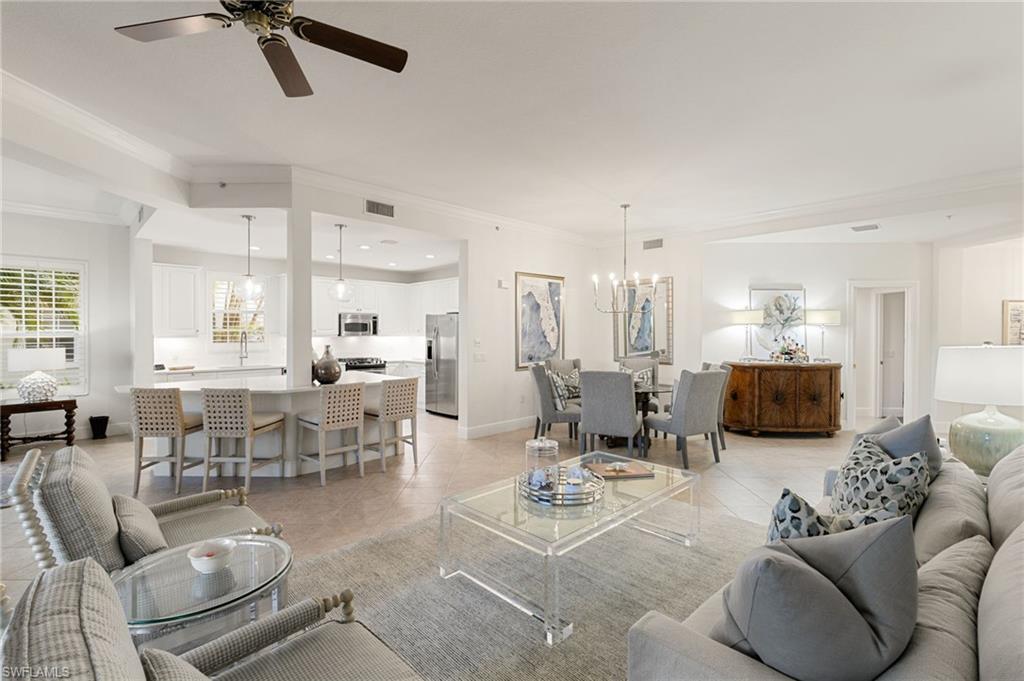 9082 Cascada Way, Unit 9102 Naples, FL 34114 - Photo 1 of 39 a living room with furniture kitchen view and a chandelier