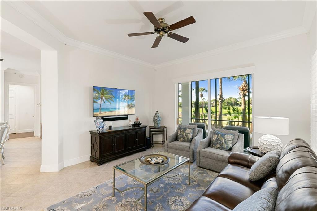 9082 Cascada Way, Unit 9102 Naples, FL 34114 - Photo 11 of 39 a living room with furniture a window and a flat screen tv