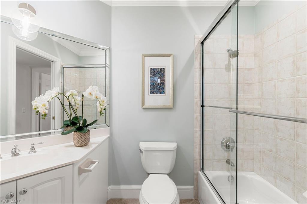 9082 Cascada Way, Unit 9102 Naples, FL 34114 - Photo 15 of 39 a bathroom with a toilet sink and shower
