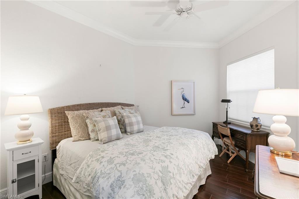 9082 Cascada Way, Unit 9102 Naples, FL 34114 - Photo 16 of 39 a bedroom with a bed and a lamp