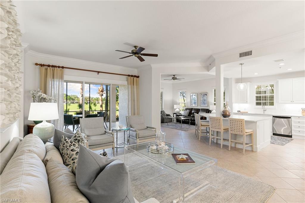 9082 Cascada Way, Unit 9102 Naples, FL 34114 - Photo 2 of 39 a living room with furniture and a large window