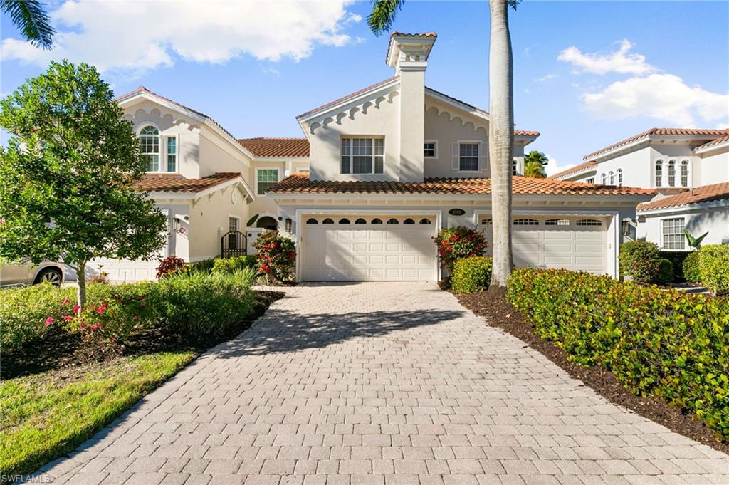 9082 Cascada Way, Unit 9102 Naples, FL 34114 - Photo 25 of 39 a front view of a house with a yard