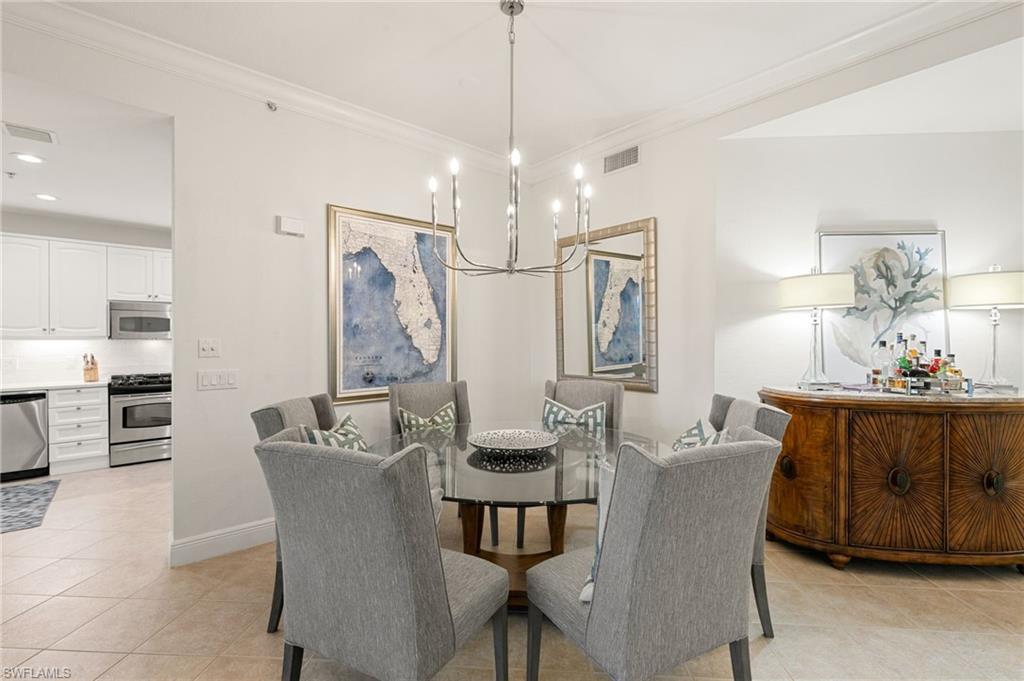 9082 Cascada Way, Unit 9102 Naples, FL 34114 - Photo 8 of 39 a view of a dining room with furniture and chandelier