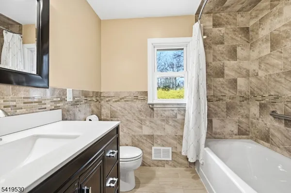 a bathroom with a sink a toilet and bathtub