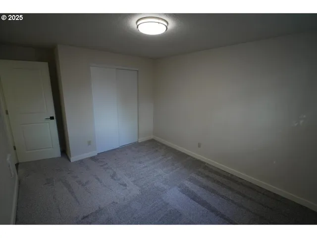 a view of an empty room and a window