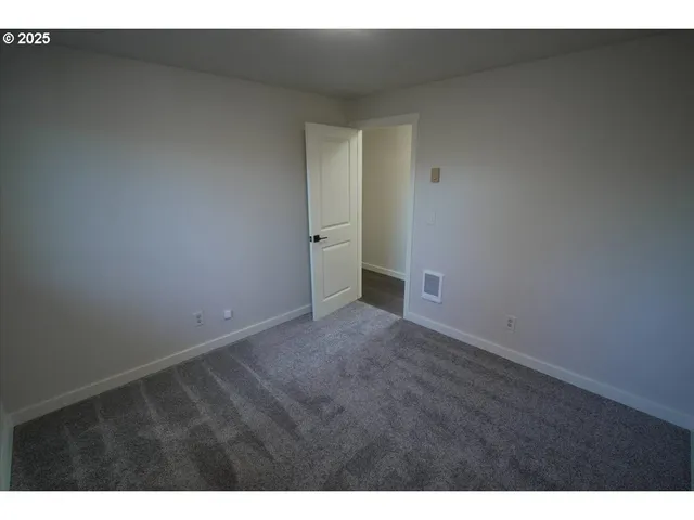 a view of an empty room and closet