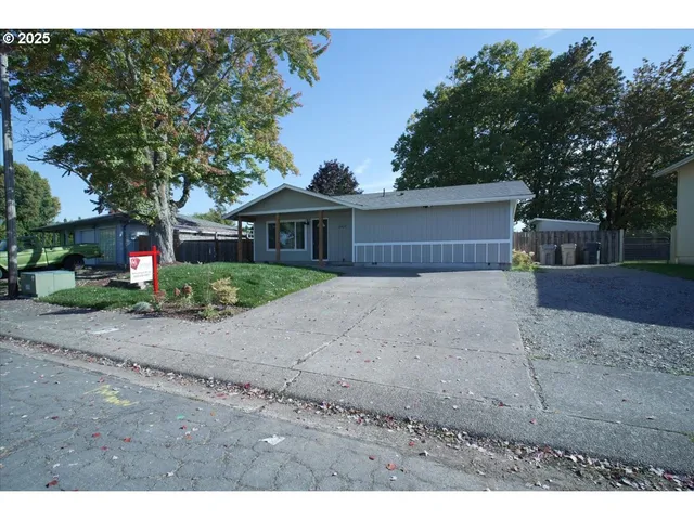 a front view of a house with a yard and a garage