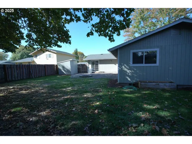 a backyard of a house with wooden fence