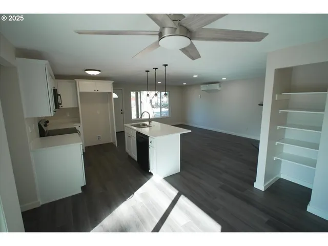 a view of a kitchen with cabinets and wooden floor