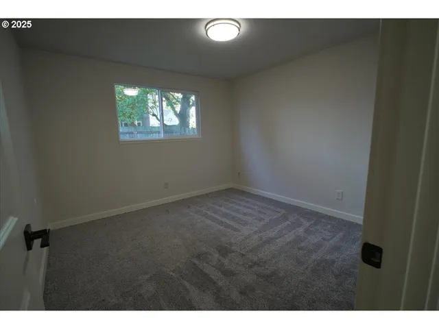 a view of an empty room and a window