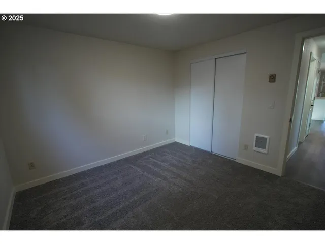 a view of an empty room and wooden floor