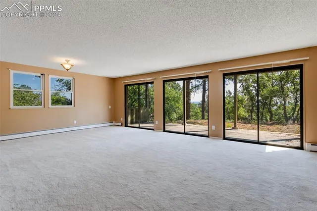 a view of a city from a balcony with furniture