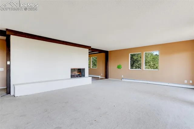 a view of empty room with a fireplace