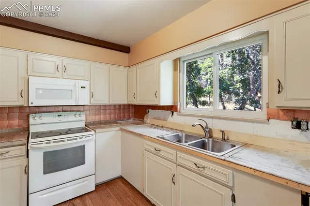 a kitchen with a sink and cabinets