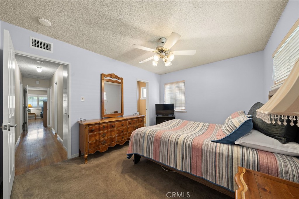 513 West Shadwell Street Carson, CA 90745 - Photo 16 of 23 a bedroom with a bed and ceiling fan