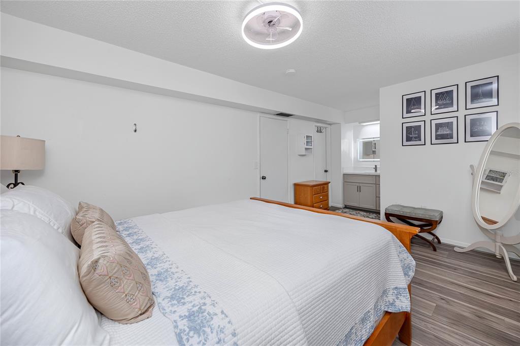 2207 Belleair Road, Unit B30 Clearwater, FL 33764 - Photo 5 of 39 a bedroom with a bed and a chandelier