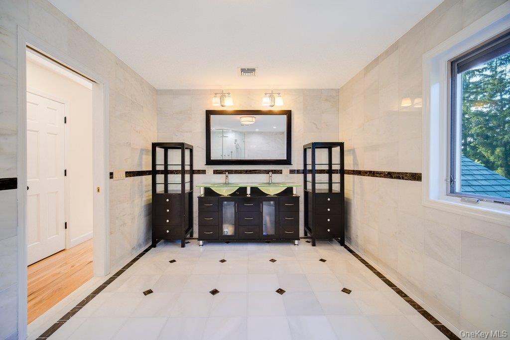 237 Mineral Springs Road Highland Mills, NY 10930 - Photo 25 of 32 Entryway featuring tile walls, light tile patterned floors, and inlaid floor details