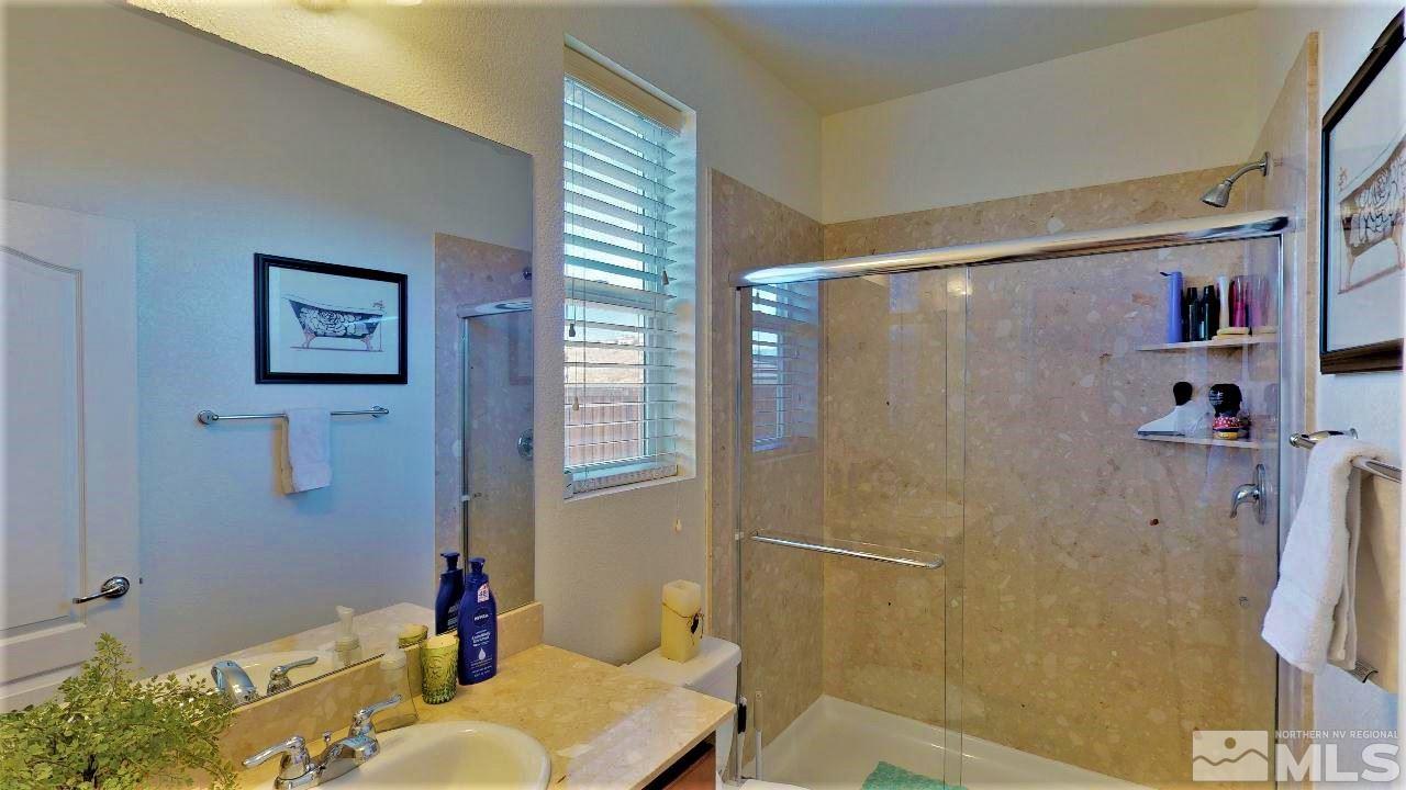 2248 Isabella Drive Sparks, NV 89434 - Photo 11 of 22 a bathroom with a tub shower and a sink
