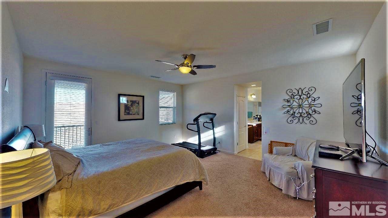 2248 Isabella Drive Sparks, NV 89434 - Photo 14 of 22 a bedroom with a bed and a chandelier