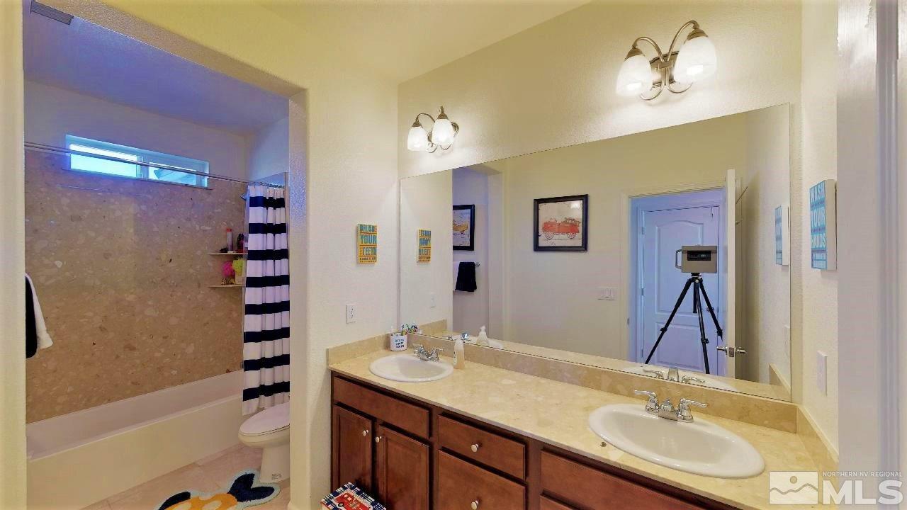 2248 Isabella Drive Sparks, NV 89434 - Photo 17 of 22 a bathroom with a sink a vanity and a mirror