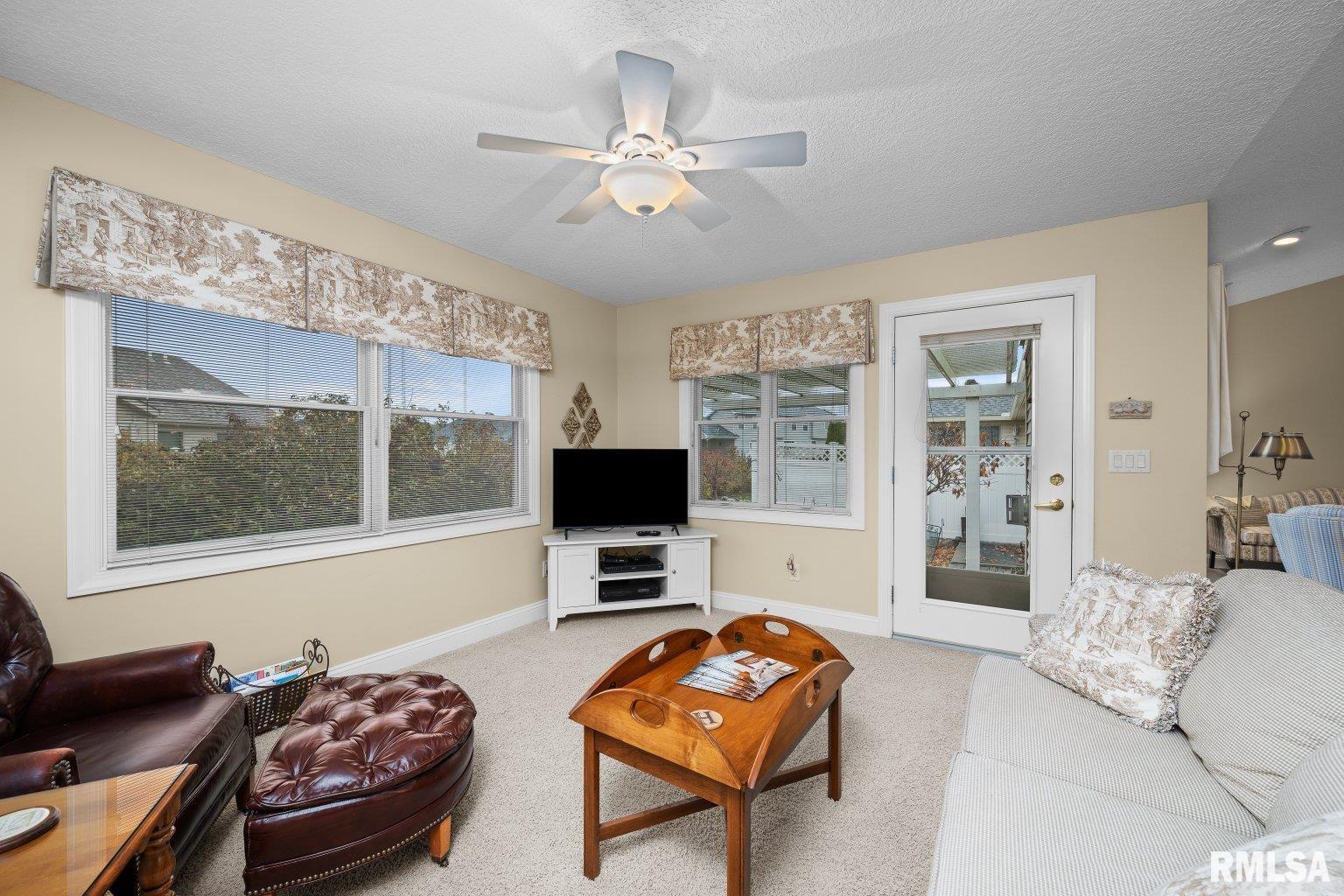451 Celeste Circle Blue Grass, IA 52726 - Photo 13 of 35 a living room with furniture and a flat screen tv