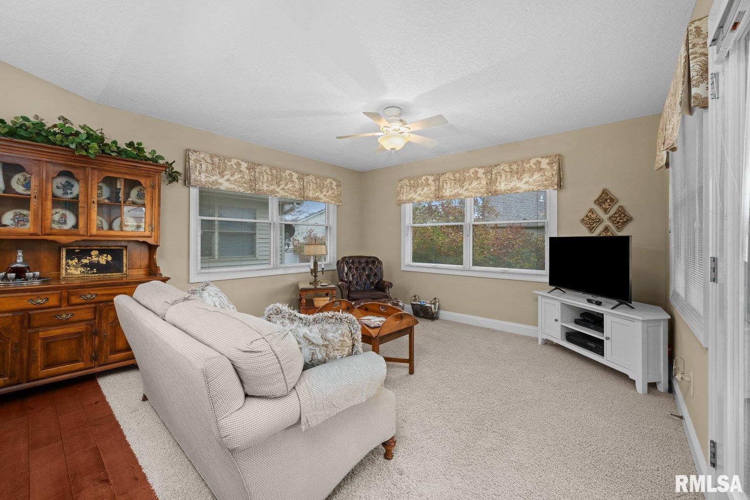 451 Celeste Circle Blue Grass, IA 52726 - Photo 14 of 35 a living room with furniture and a flat screen tv