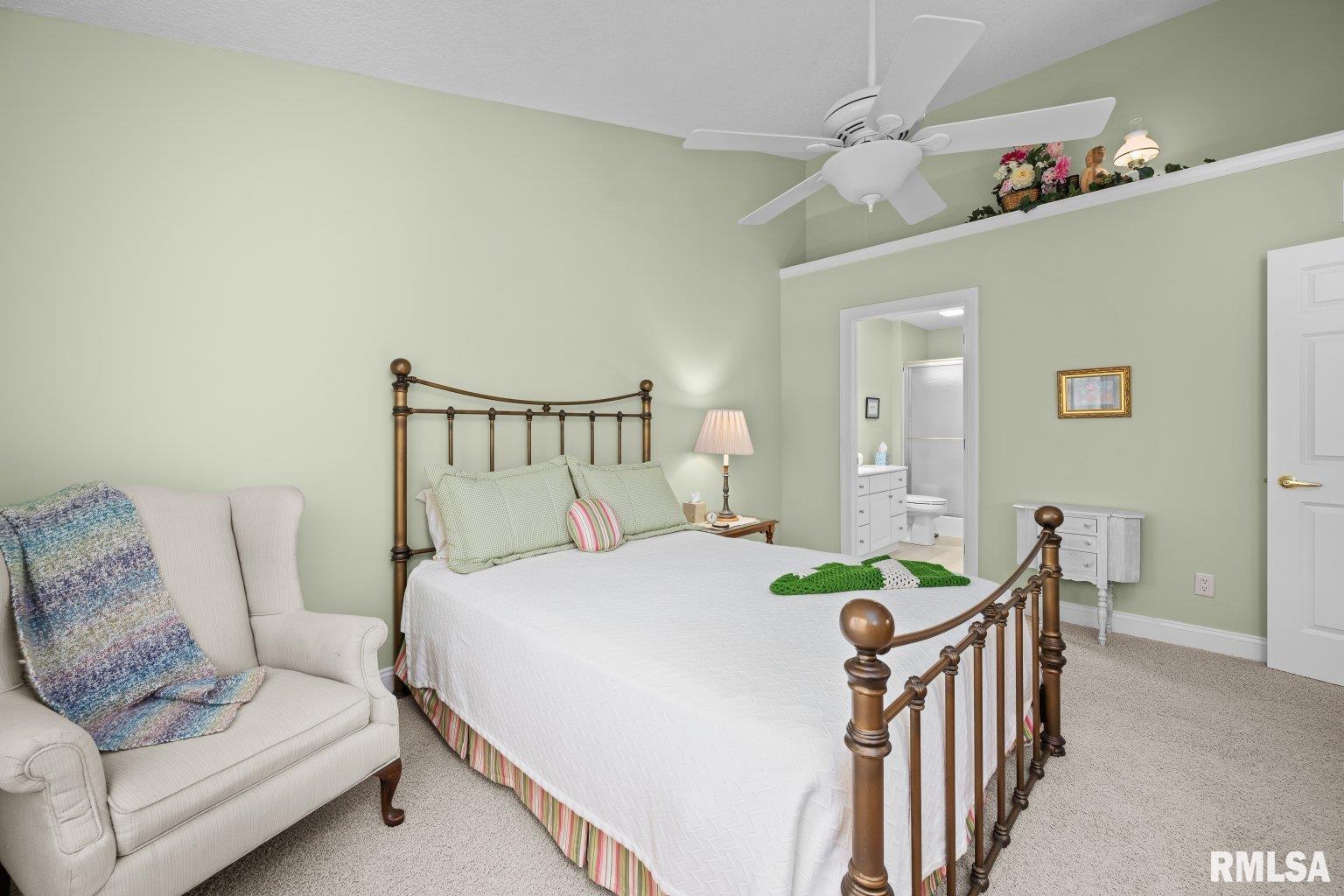 451 Celeste Circle Blue Grass, IA 52726 - Photo 15 of 35 a bedroom with a bed and a chandelier