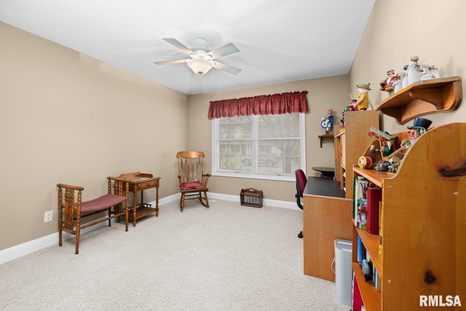 451 Celeste Circle Blue Grass, IA 52726 - Photo 24 of 35 a view of a workspace with furniture and a window