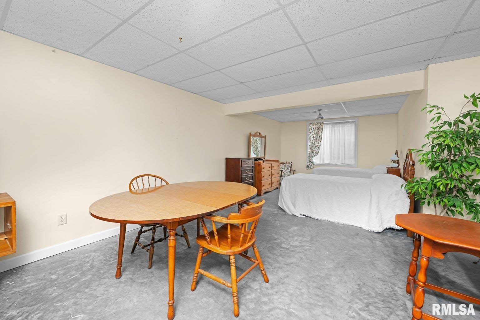 451 Celeste Circle Blue Grass, IA 52726 - Photo 28 of 35 a view of a dining room with furniture and a potted plant