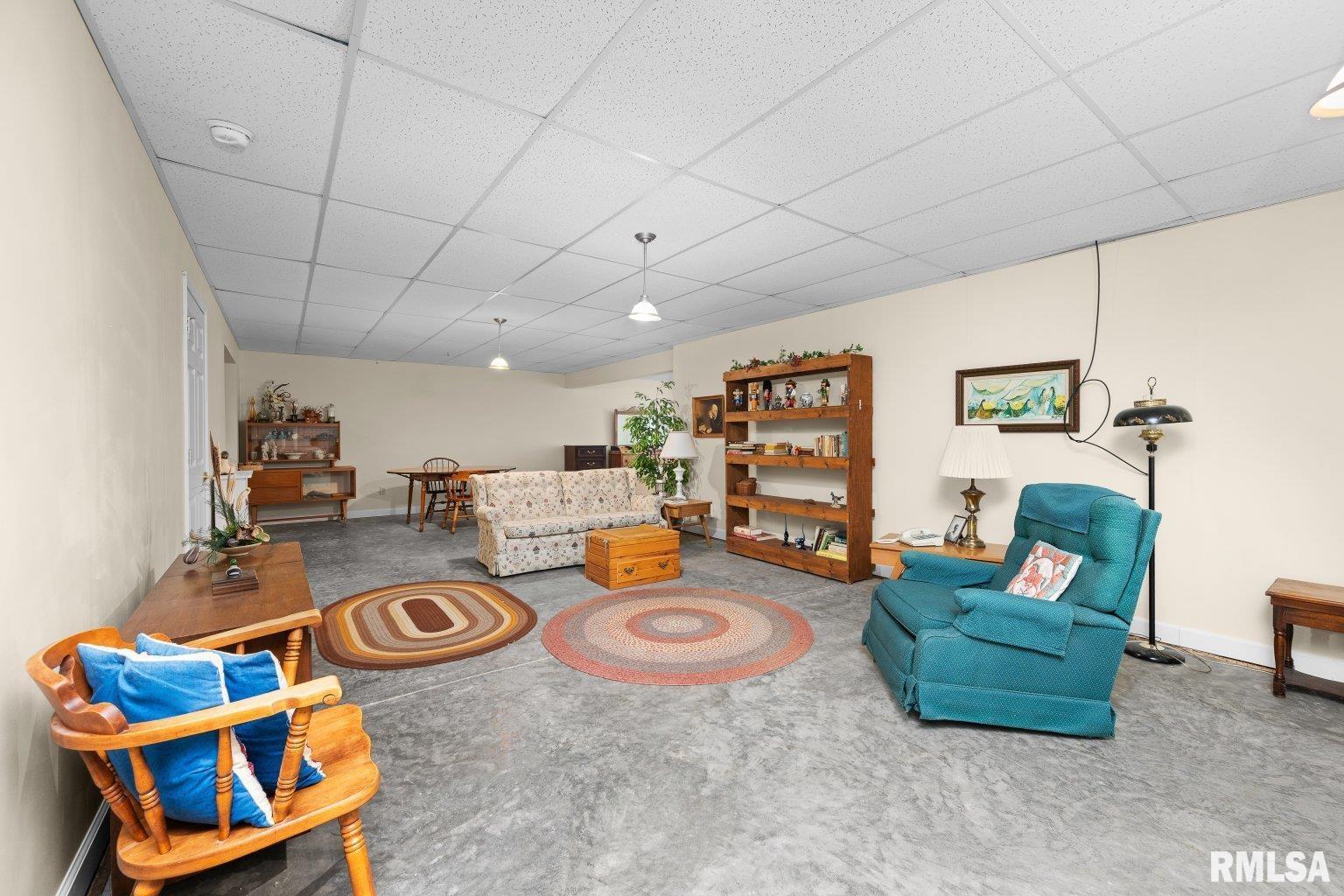 451 Celeste Circle Blue Grass, IA 52726 - Photo 30 of 35 a living room with furniture and a flat screen tv