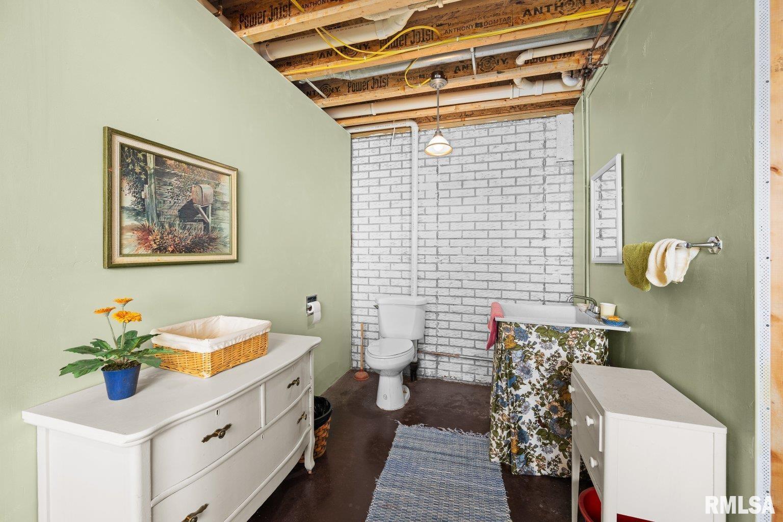 451 Celeste Circle Blue Grass, IA 52726 - Photo 31 of 35 a bathroom with a sink a toilet and shower