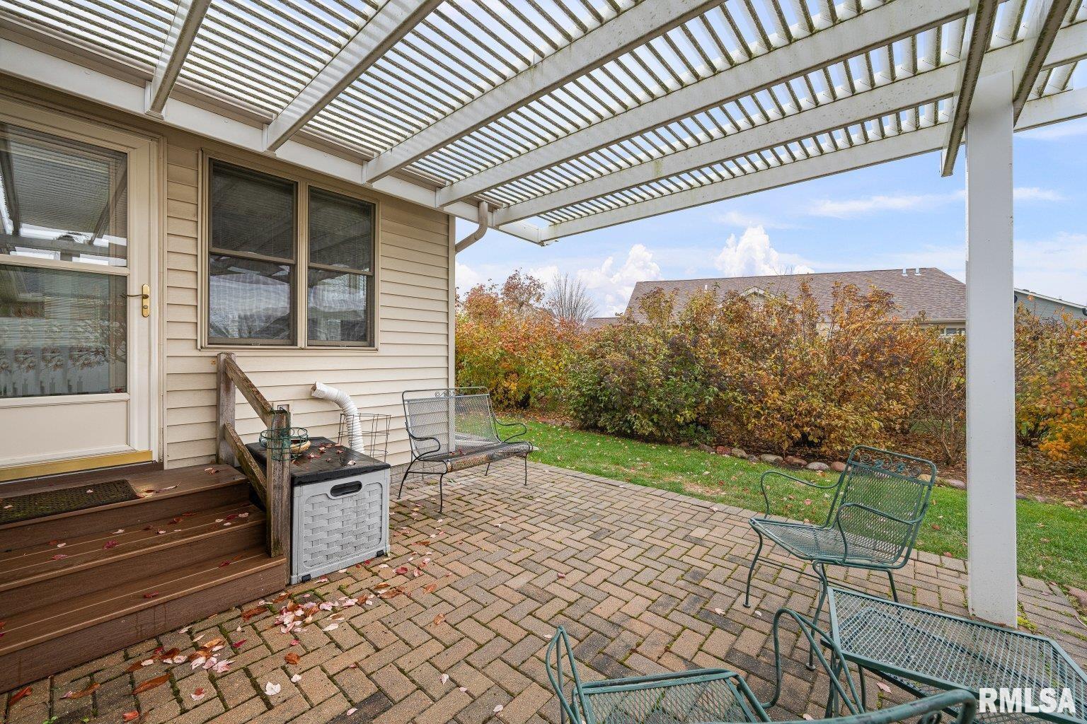 451 Celeste Circle Blue Grass, IA 52726 - Photo 34 of 35 a view of a porch with furniture and garden
