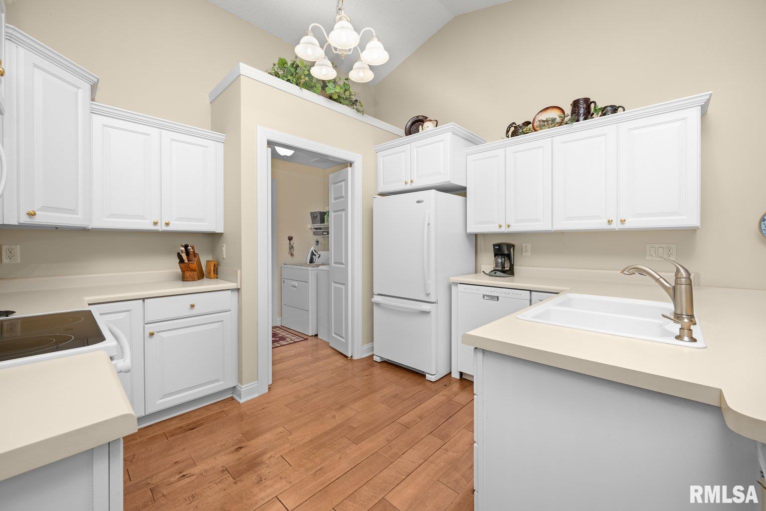 451 Celeste Circle Blue Grass, IA 52726 - Photo 5 of 35 a kitchen with a sink stove and refrigerator