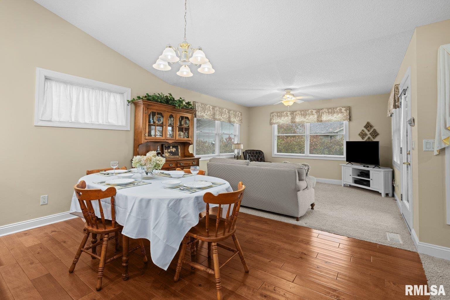 451 Celeste Circle Blue Grass, IA 52726 - Photo 7 of 35 a view of a dining room with furniture window and wooden floor