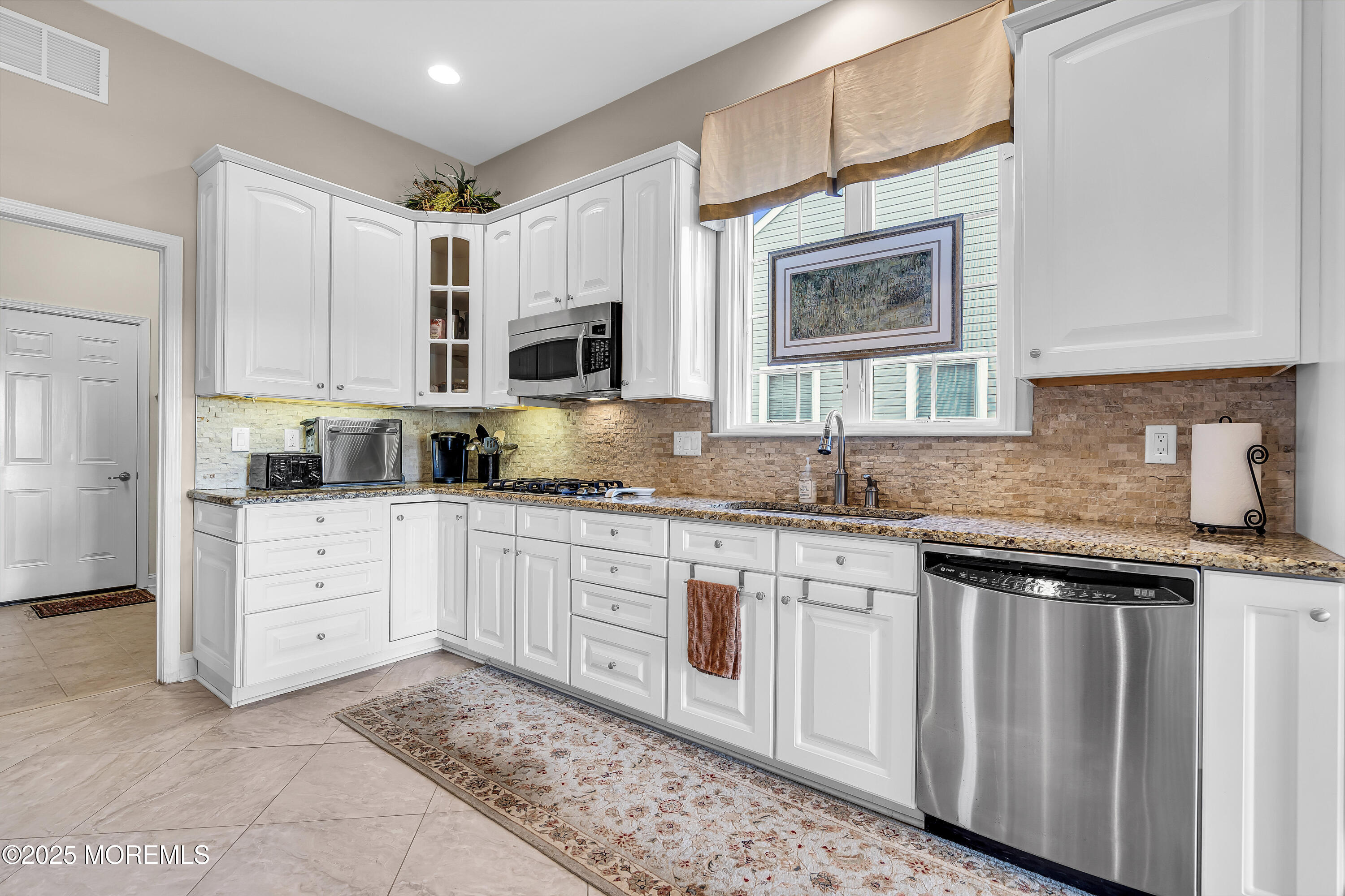14 Harvey Cedar Way Waretown, NJ 08758 - Photo 23 of 59 a kitchen with granite countertop white cabinets white appliances and sink