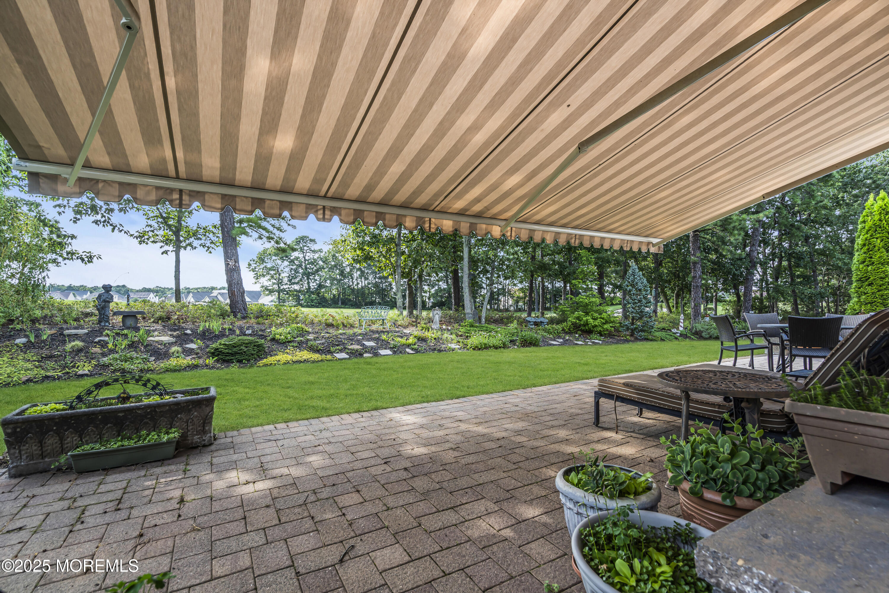 14 Harvey Cedar Way Waretown, NJ 08758 - Photo 52 of 59 a view of a backyard with couches under an umbrella
