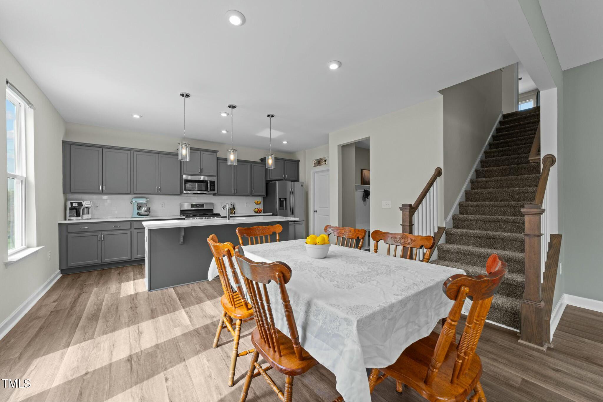 118 Lockhaven Drive Garner, NC 27529 - Photo 10 of 56 a kitchen with a table chairs sink microwave and cabinets