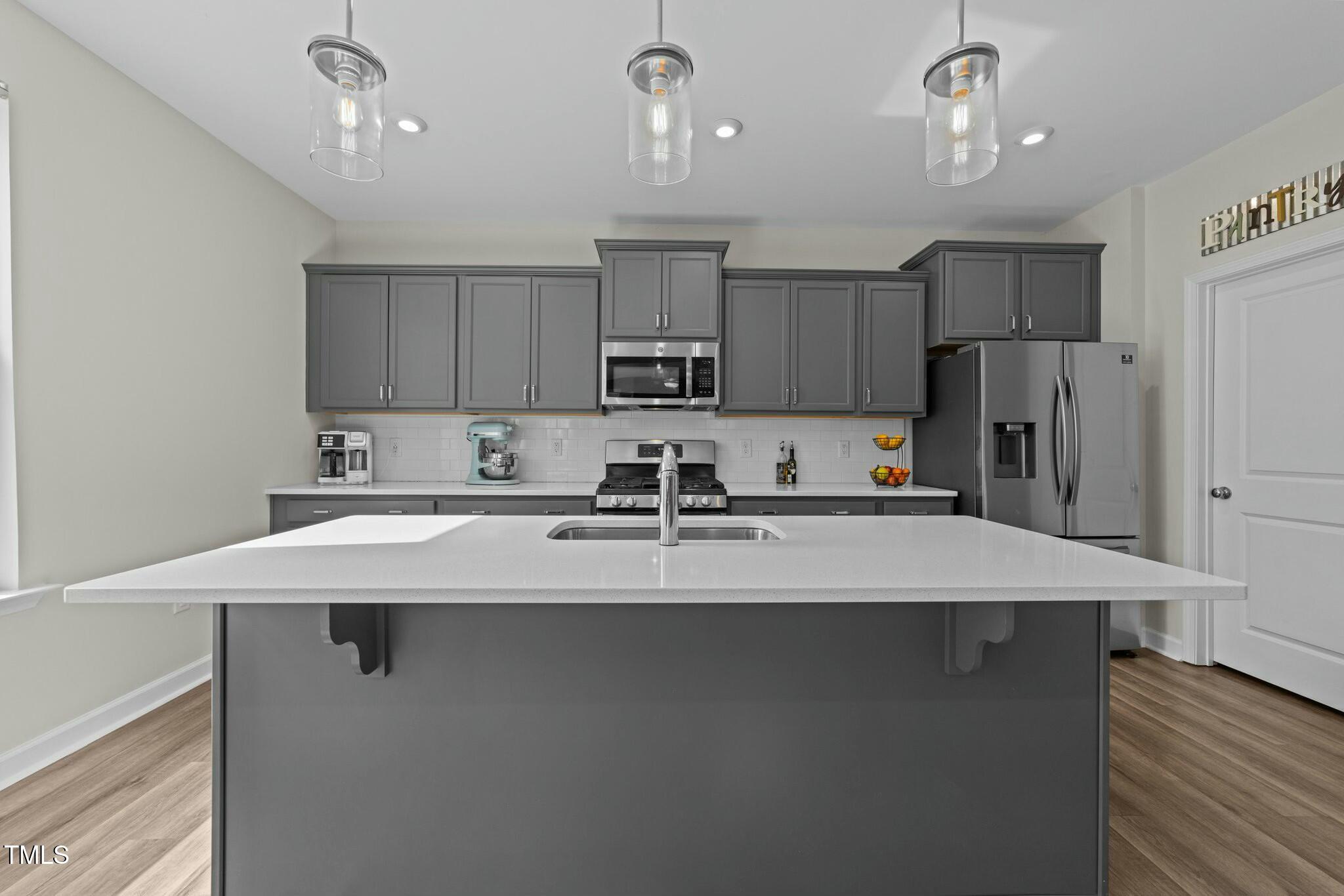 118 Lockhaven Drive Garner, NC 27529 - Photo 12 of 56 a kitchen with stainless steel appliances granite countertop a sink refrigerator and a stove