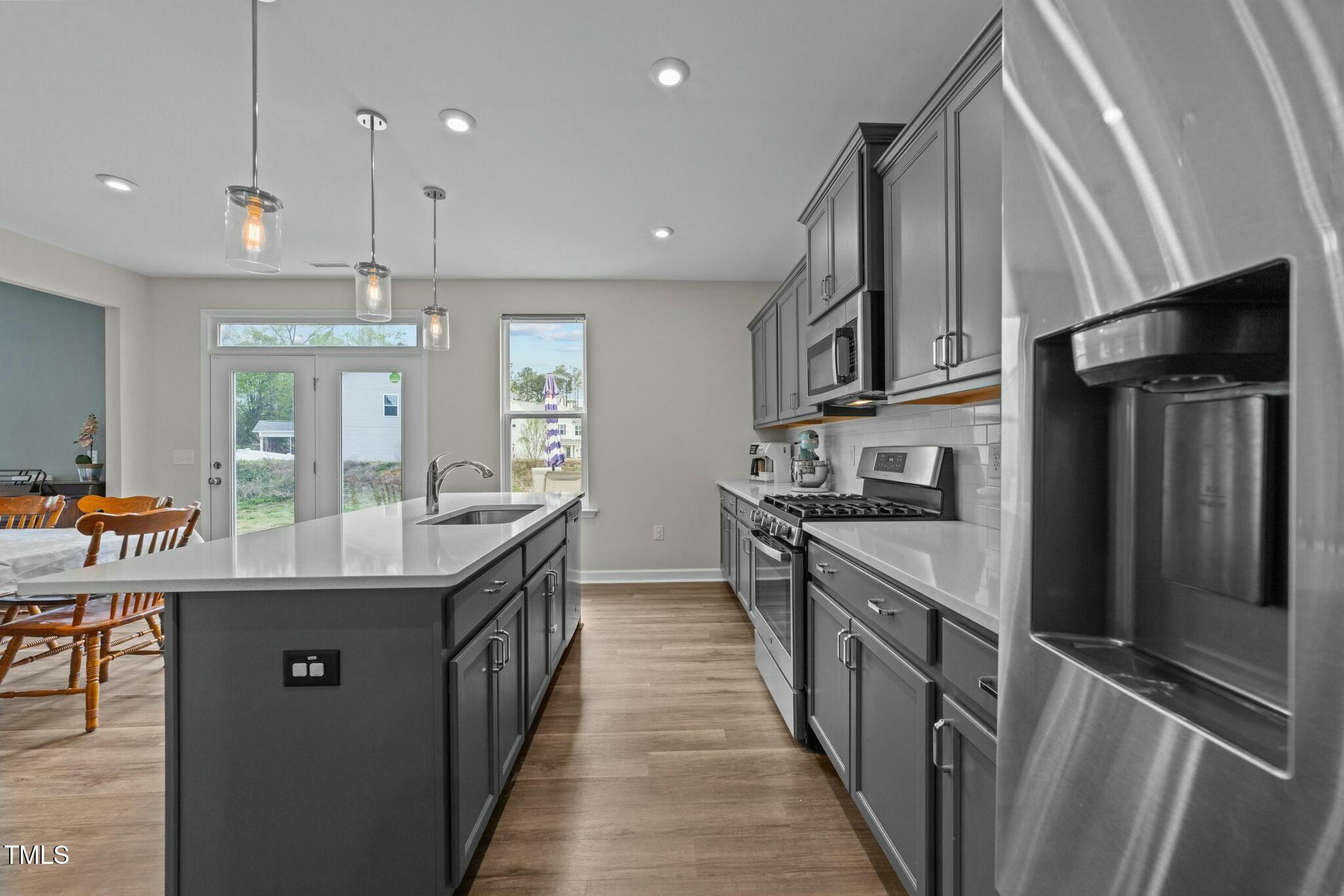 118 Lockhaven Drive Garner, NC 27529 - Photo 13 of 56 a kitchen with stainless steel appliances granite countertop a sink a stove and a refrigerator