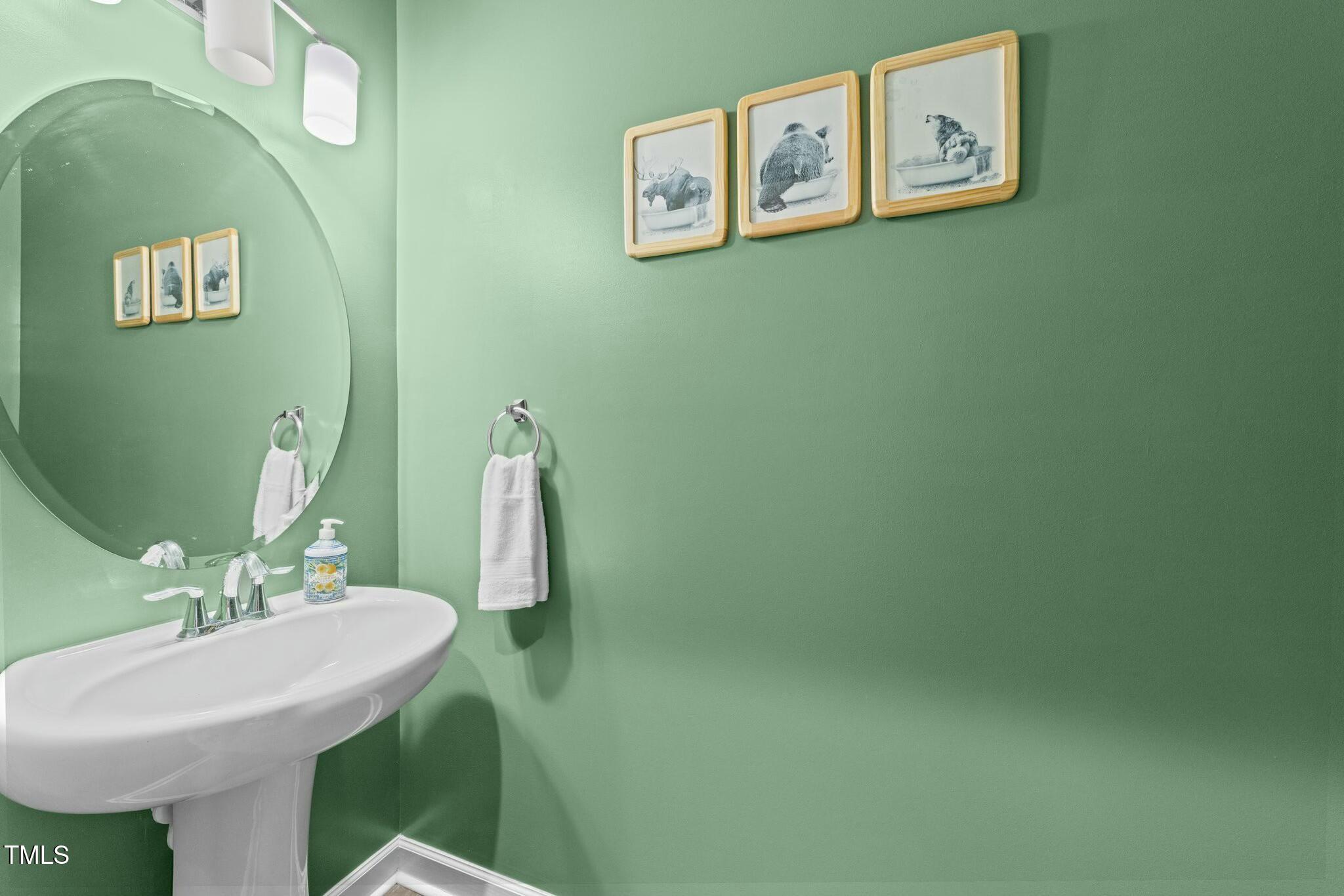 118 Lockhaven Drive Garner, NC 27529 - Photo 16 of 56 a bathroom with a sink and a mirror