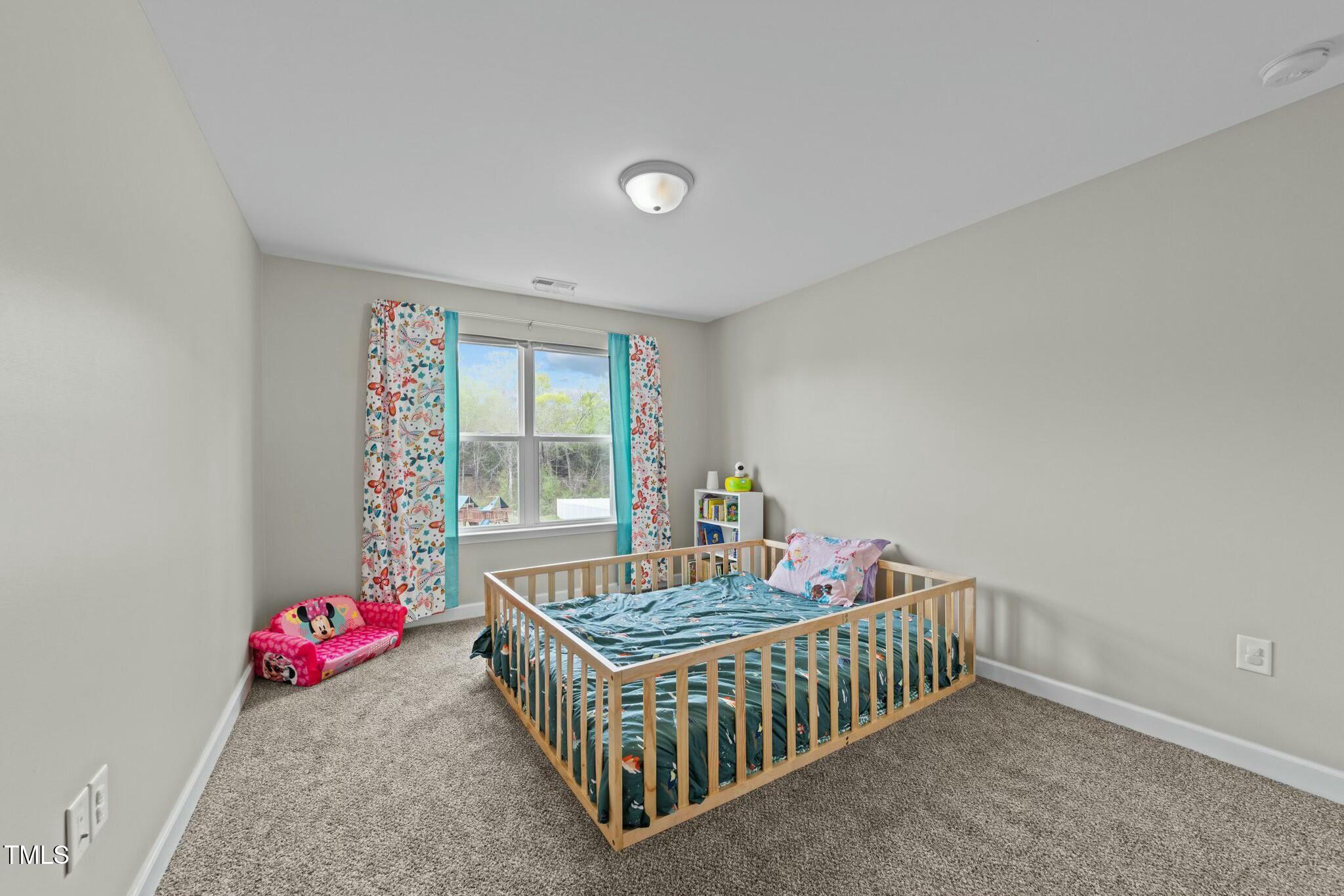 118 Lockhaven Drive Garner, NC 27529 - Photo 26 of 56 a bedroom with furniture and a window