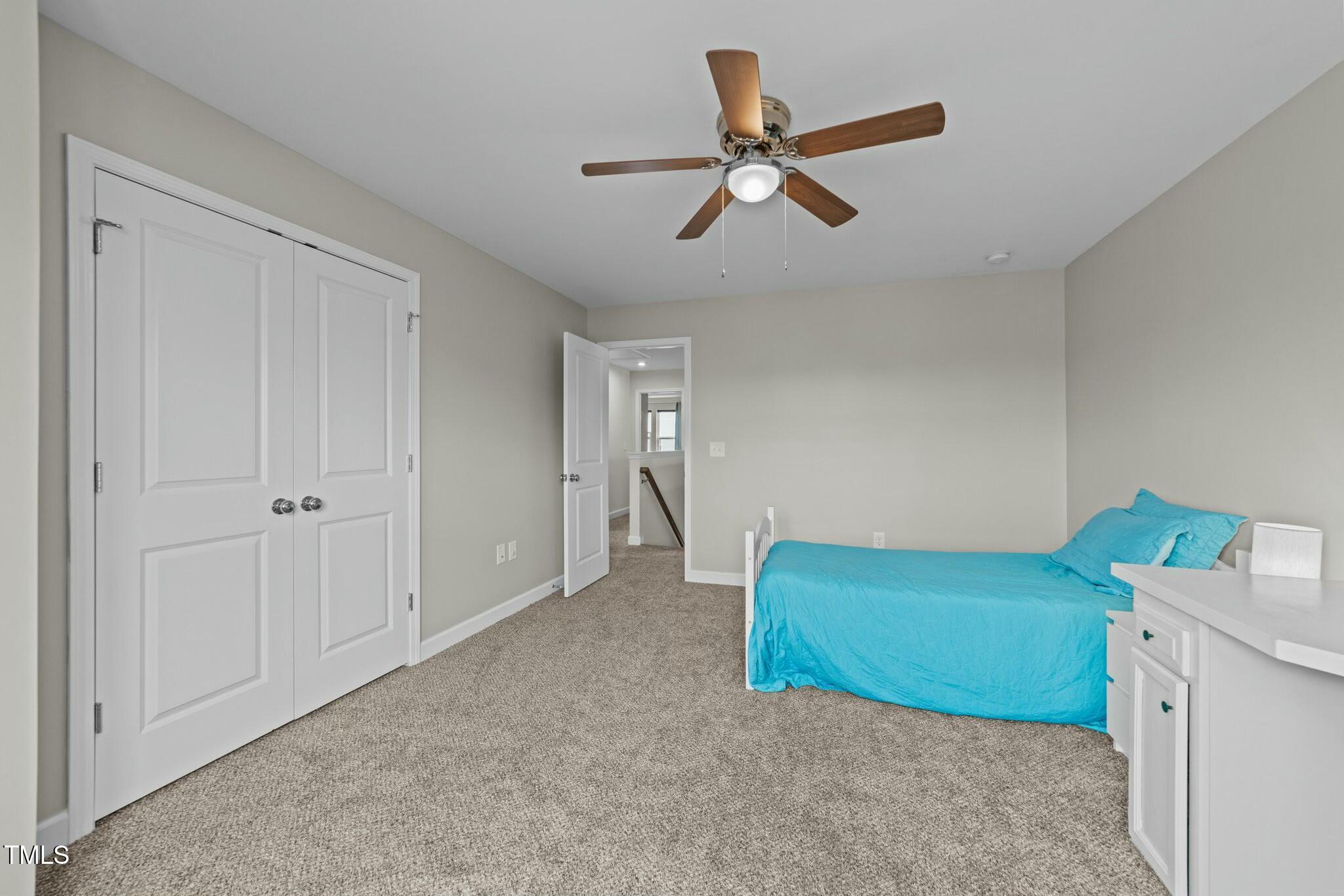 118 Lockhaven Drive Garner, NC 27529 - Photo 30 of 56 a view of a livingroom with a ceiling fan & staircase