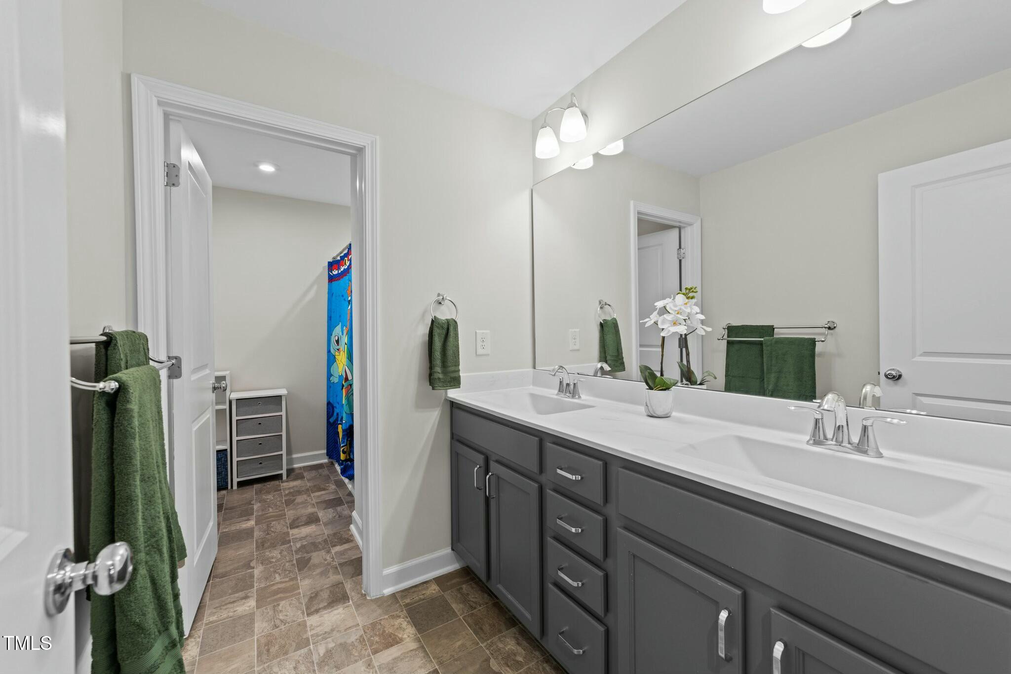 118 Lockhaven Drive Garner, NC 27529 - Photo 31 of 56 a spacious bathroom with a double vanity sink and a mirror