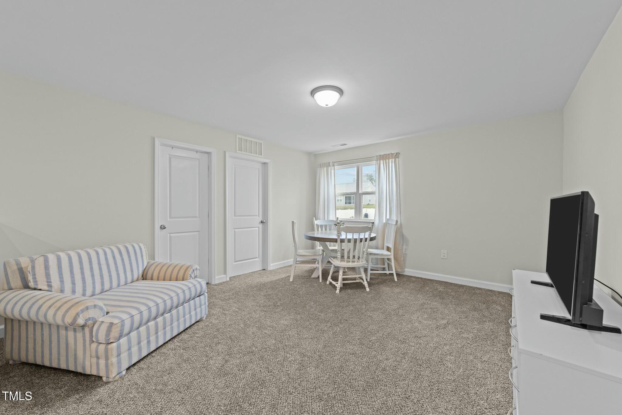 118 Lockhaven Drive Garner, NC 27529 - Photo 33 of 56 a living room with furniture and a flat screen tv