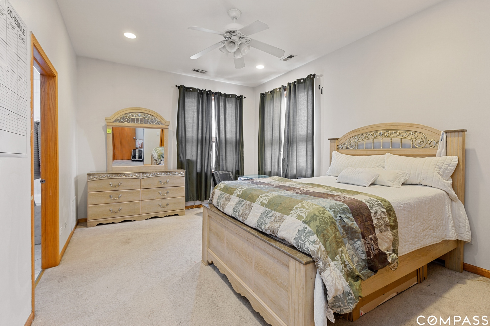 2136 West Monroe Street, Unit 204 Chicago, IL 60612 - Photo 11 of 15 a spacious bedroom with a bed and a chandelier