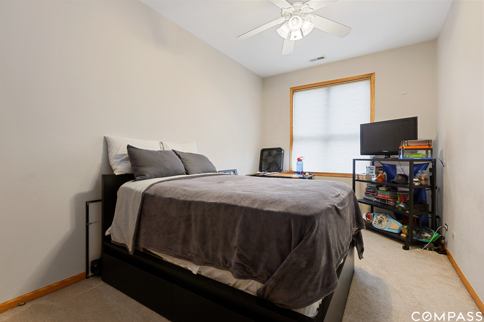 2136 West Monroe Street, Unit 204 Chicago, IL 60612 - Photo 13 of 15 a bedroom with a bed and a chandelier