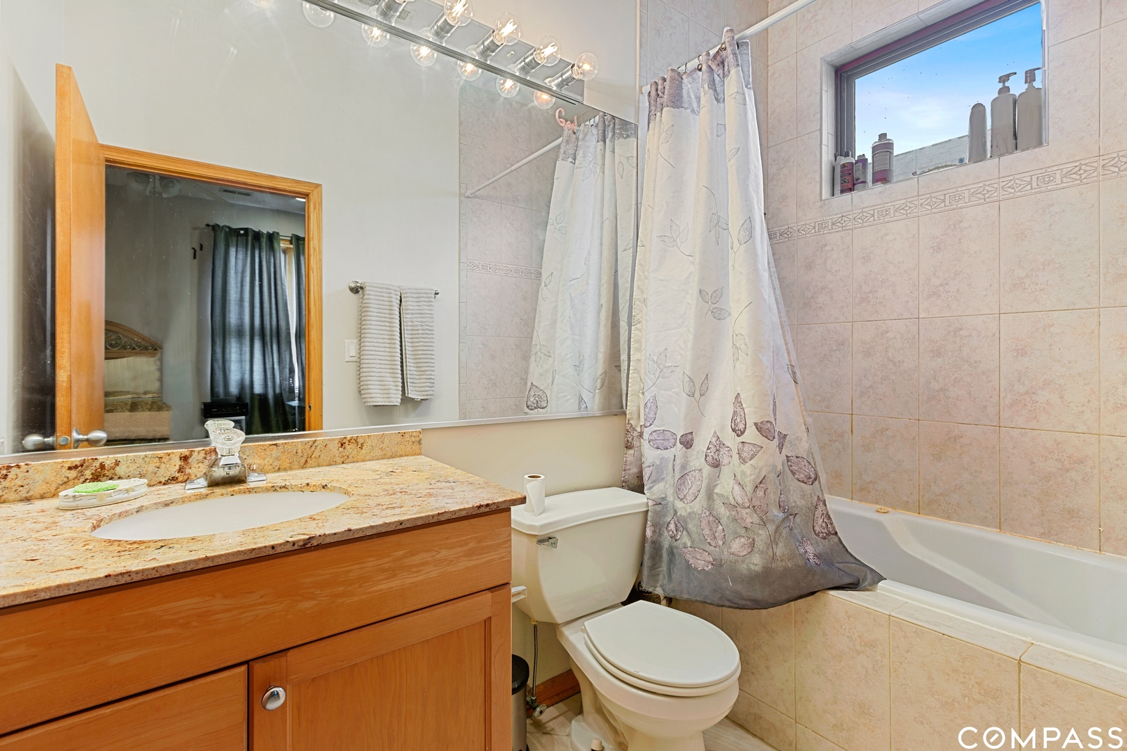 2136 West Monroe Street, Unit 204 Chicago, IL 60612 - Photo 14 of 15 a bathroom with a granite countertop sink toilet and shower