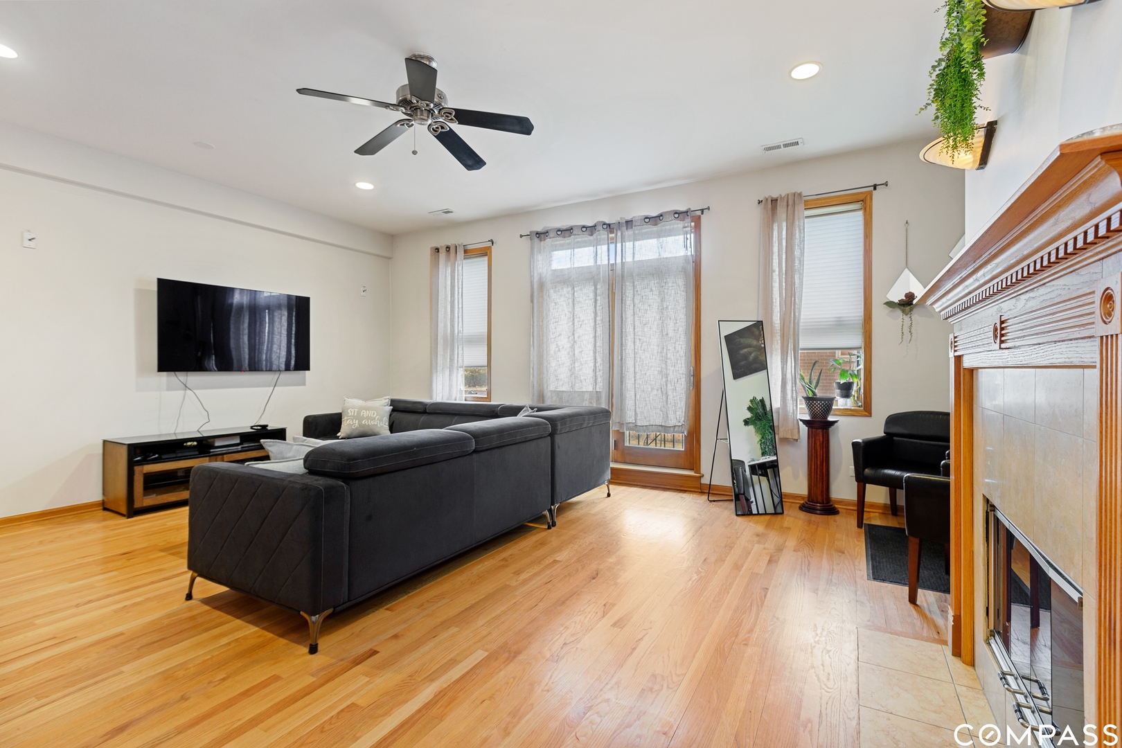 2136 West Monroe Street, Unit 204 Chicago, IL 60612 - Photo 5 of 15 a living room with furniture flat screen tv and wooden floor