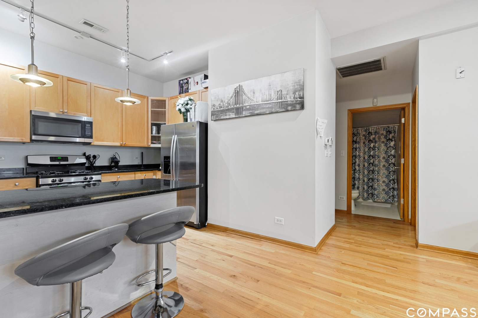 2136 West Monroe Street, Unit 204 Chicago, IL 60612 - Photo 8 of 15 a kitchen with stainless steel appliances granite countertop a refrigerator and a stove top oven